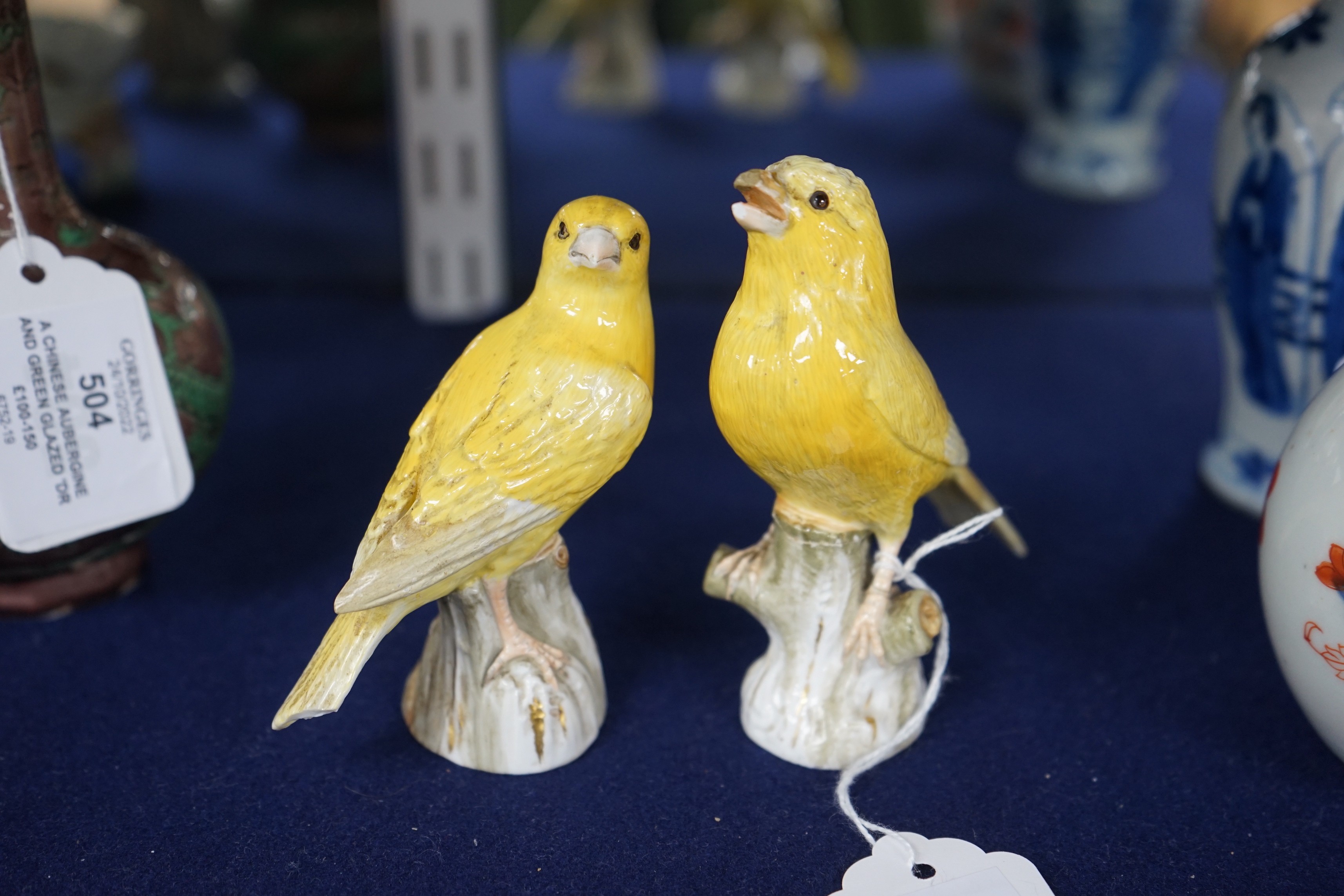A pair of Meissen figures of canaries, 10cm tall